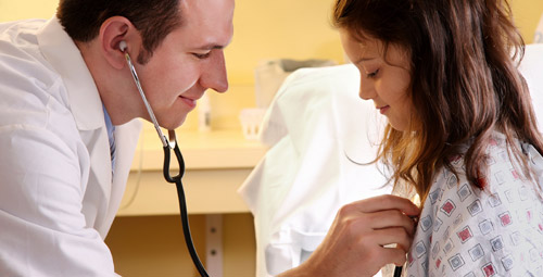 Doctor using a stethoscope on a patient